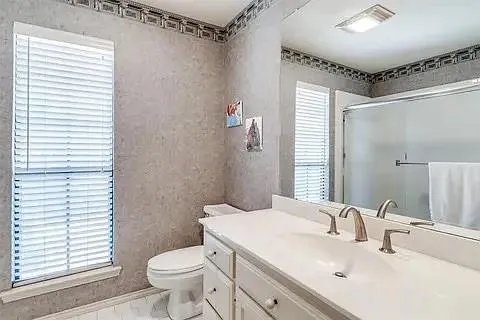 a bathroom with a sink toilet and shower