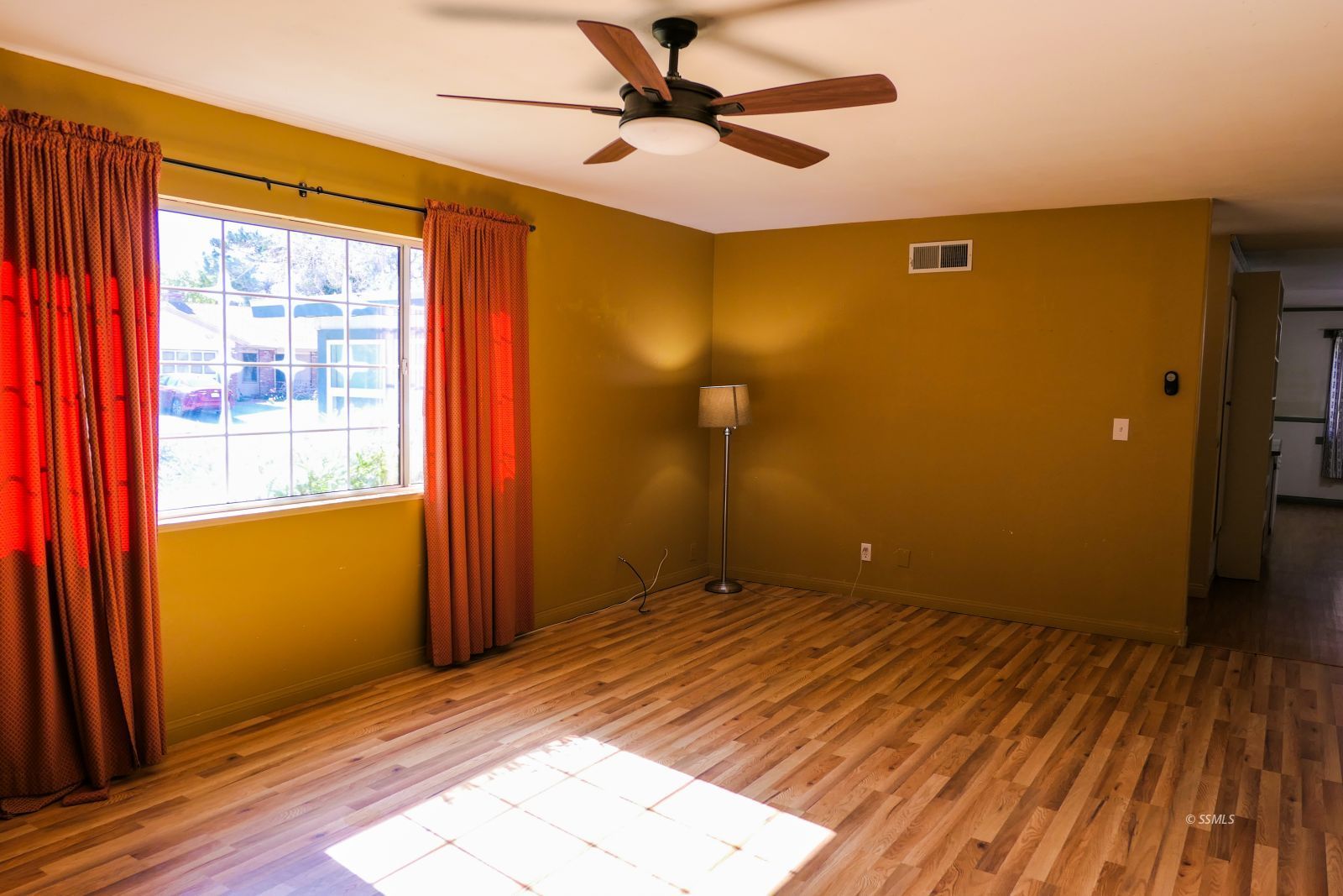 220 West Benson Avenue Ridgecrest, CA 93555 - Photo 6 of 38 an empty room with wooden floor and windows