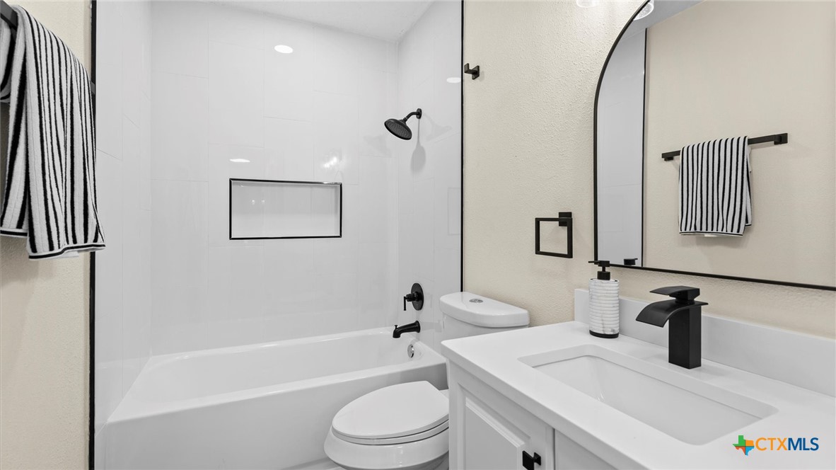 300 Ridge Crest Drive Seguin, TX 78155 - Photo 12 of 33 a bathroom with a sink a toilet and shower