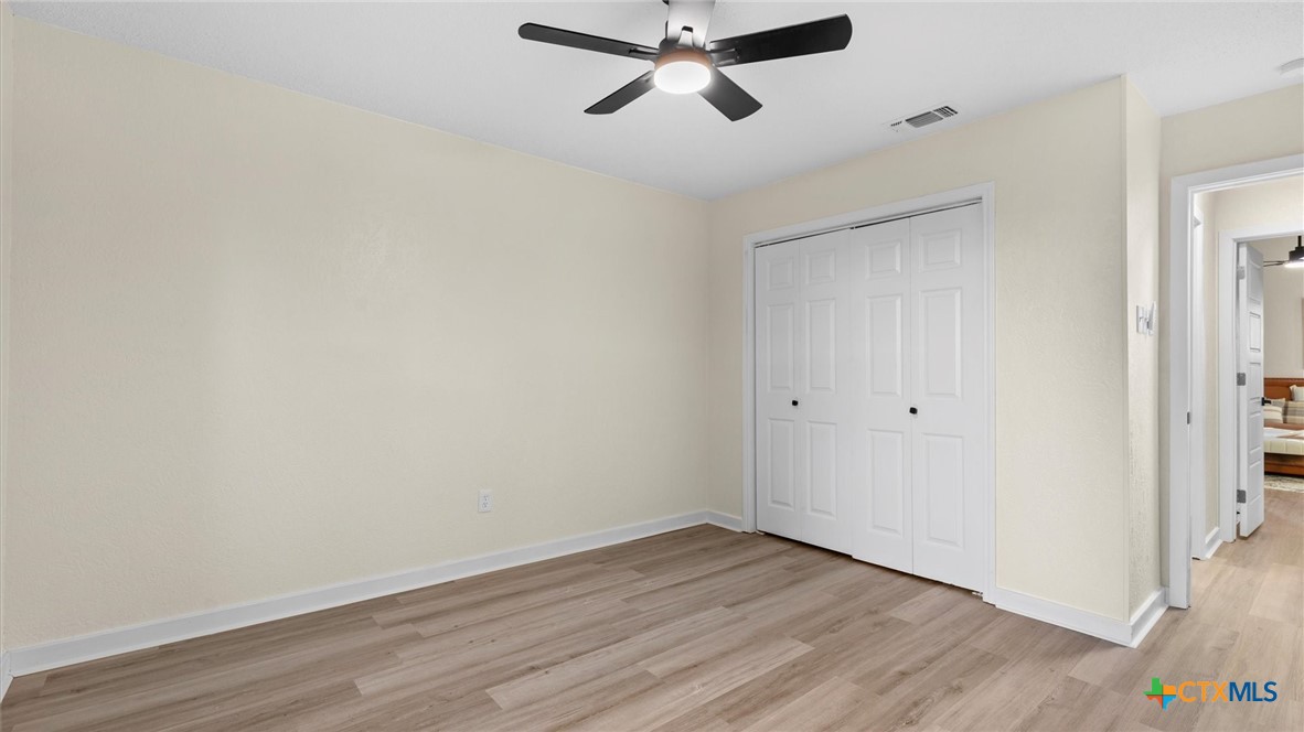 300 Ridge Crest Drive Seguin, TX 78155 - Photo 14 of 33 a view of a room with wooden floor and ceiling fan