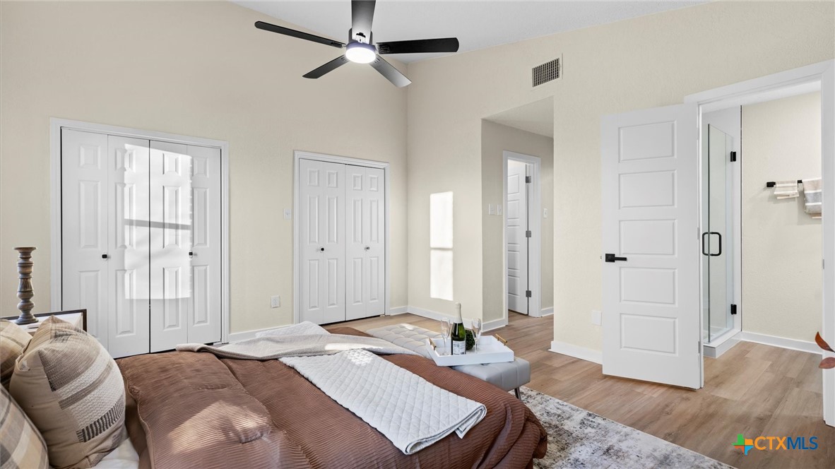 300 Ridge Crest Drive Seguin, TX 78155 - Photo 16 of 33 a bedroom with a bed and a chandelier