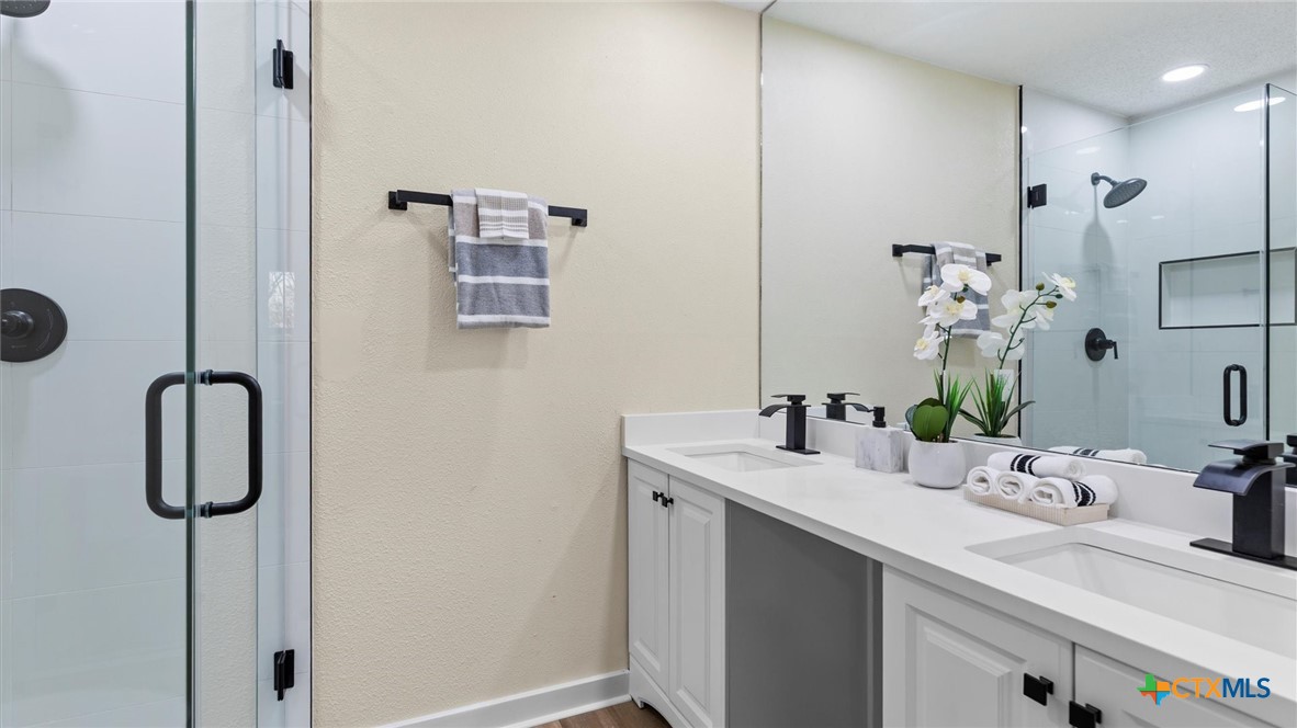 300 Ridge Crest Drive Seguin, TX 78155 - Photo 17 of 33 a bathroom with a sink and mirror