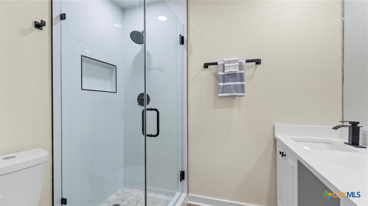 300 Ridge Crest Drive Seguin, TX 78155 - Photo 18 of 33 a bathroom with a sink and mirror