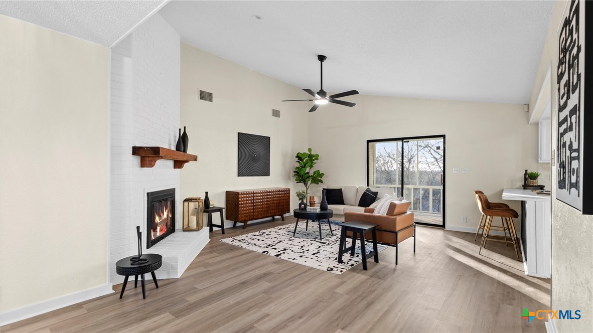 300 Ridge Crest Drive Seguin, TX 78155 - Photo 4 of 33 a living room with furniture a fireplace and a flat screen tv