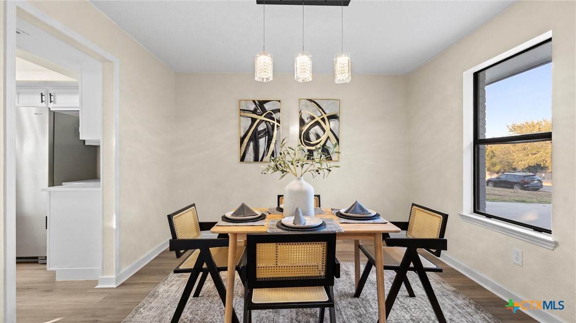300 Ridge Crest Drive Seguin, TX 78155 - Photo 6 of 33 a view of a dining room with furniture and wooden floor