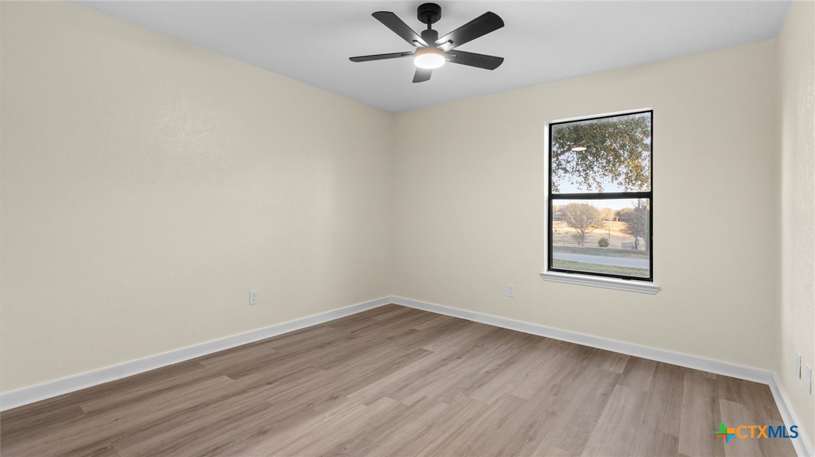 300 Ridge Crest Drive Seguin, TX 78155 - Photo 10 of 33 a view of a big room with wooden floor and windows