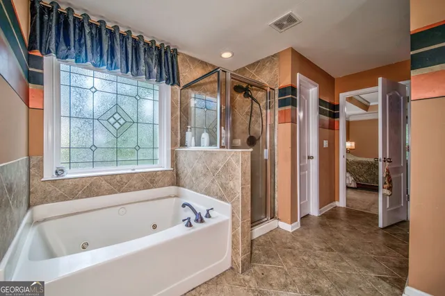 a bathroom with a bathtub and a shower