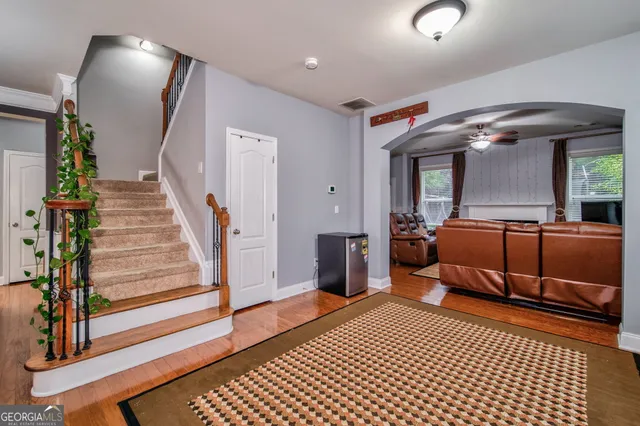 a bedroom with furniture and a mirror