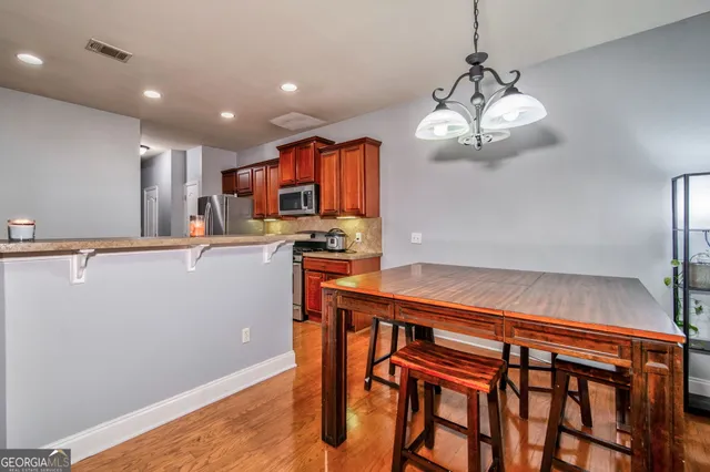 a kitchen with stainless steel appliances granite countertop a refrigerator and a stove top oven