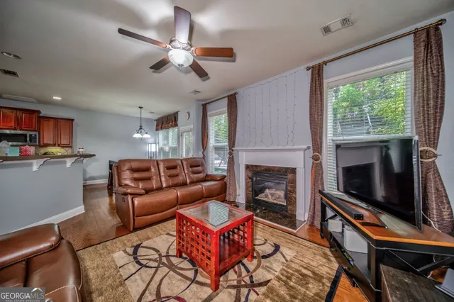 a living room with furniture a flat screen tv and a fireplace