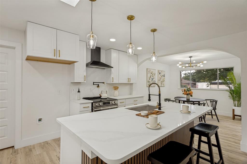 3816 Springbranch Drive Benbrook, TX 76116 - Photo 8 of 25 a open kitchen with stainless steel appliances granite countertop a stove a refrigerator a sink a dining table and chairs with wooden floor