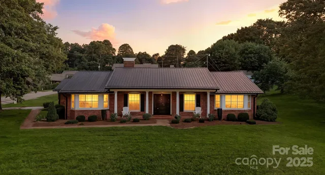 a front view of a house with a yard and outdoor seating