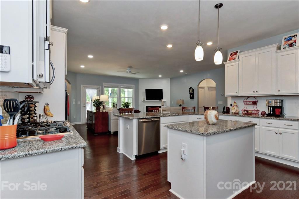 4978 Samoa Ridge Drive Lancaster, SC 29720 - Photo 13 of 38 a kitchen with sink stove and white cabinets with wooden floor