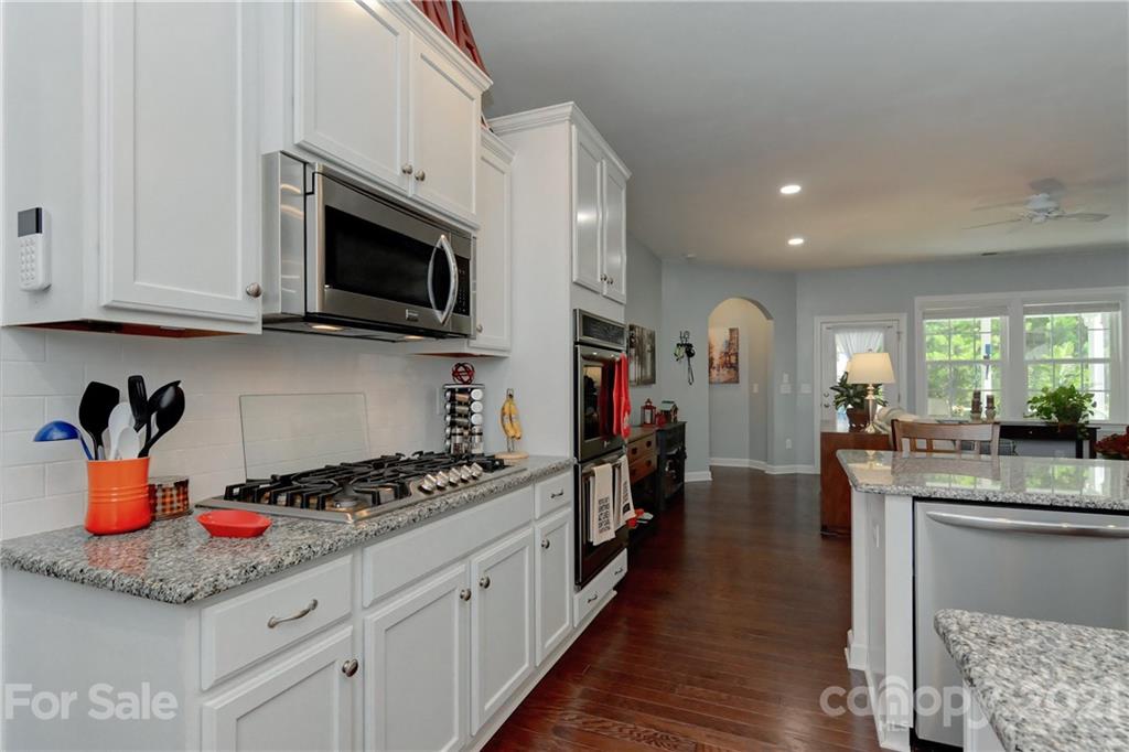 4978 Samoa Ridge Drive Lancaster, SC 29720 - Photo 15 of 38 a kitchen with stainless steel appliances kitchen island granite countertop a stove and a sink