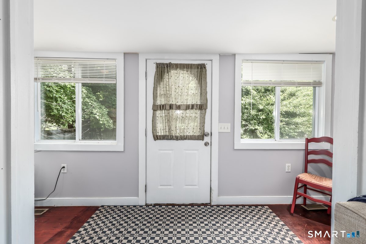 70 Dodgingtown Road Bethel, CT 06801 - Photo 2 of 27 a room that has a chair and wooden floor