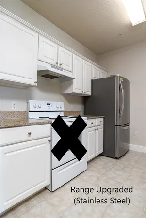 a kitchen with a refrigerator a stove and cabinets