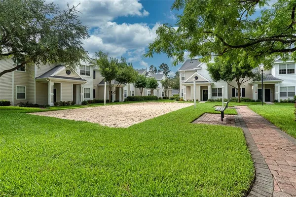 a front view of a house with a yard and trees