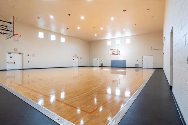 a view of a kitchen with kitchen island a sink a stove and a refrigerator