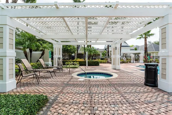 a building outdoor space with patio furniture and potted plants