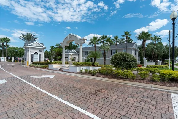a front view of house with yard and trees around