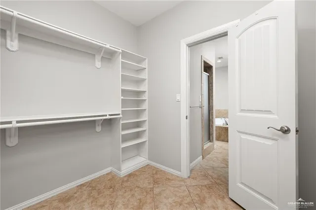 a view of walk in closet with empty racks