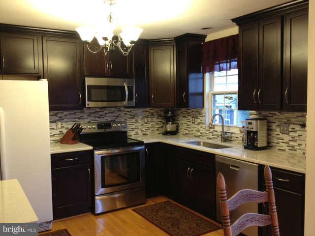 730 Monarch Ridge Road Frederick, MD 21703 - Photo 2 of 30 a kitchen with stainless steel appliances granite countertop a sink stove and refrigerator