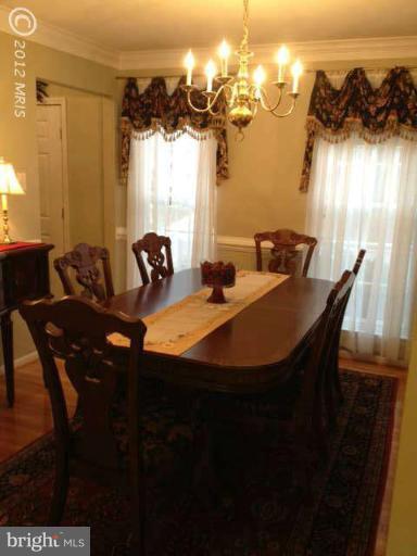 730 Monarch Ridge Road Frederick, MD 21703 - Photo 13 of 30 a dining room with furniture and a chandelier