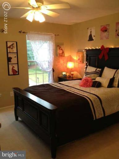 730 Monarch Ridge Road Frederick, MD 21703 - Photo 17 of 30 a bedroom with a bed and a chandelier