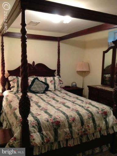 730 Monarch Ridge Road Frederick, MD 21703 - Photo 19 of 30 a bedroom with a bed and a painting on the wall