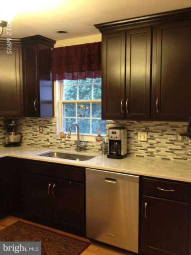 730 Monarch Ridge Road Frederick, MD 21703 - Photo 3 of 30 a kitchen with stainless steel appliances granite countertop wooden cabinets and a sink