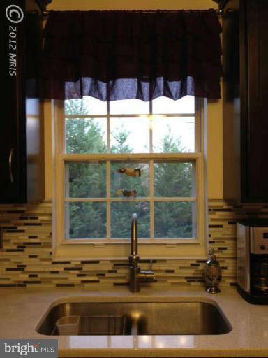 730 Monarch Ridge Road Frederick, MD 21703 - Photo 5 of 30 a kitchen sink with a granite countertop in it
