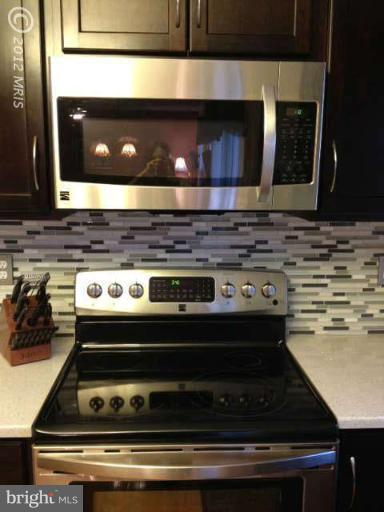 730 Monarch Ridge Road Frederick, MD 21703 - Photo 6 of 30 a stove top oven sitting inside of a kitchen