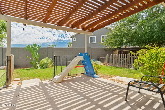 a view of a backyard with a table and chairs
