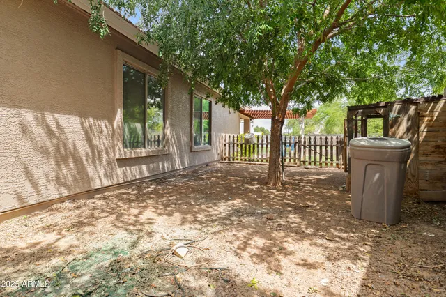 a view of a house with wooden fence