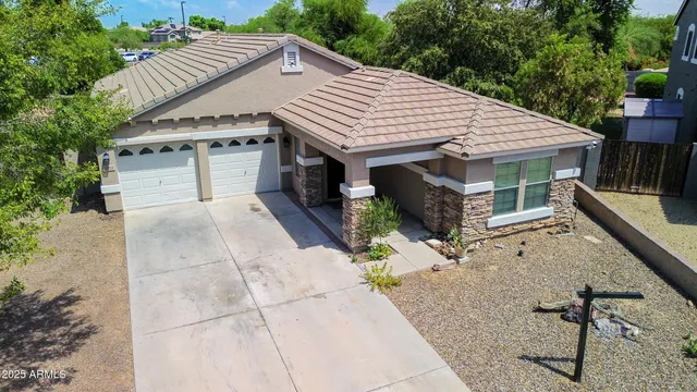 a view of house with backyard and glass windows