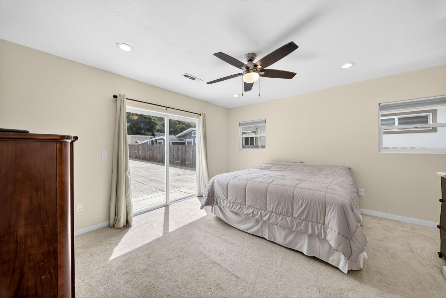 919 Old Canyon Road Fremont, CA 94536 - Photo 15 of 55 a spacious bedroom with a large bed and a chandelier