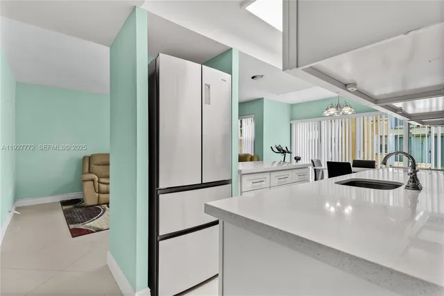 a kitchen with a refrigerator a sink and a cabinets