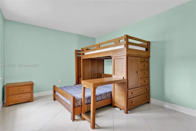 a bedroom with a bunk bed and a dresser in it
