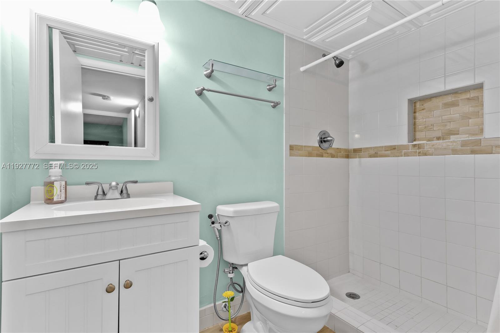 9311 Southwest 4th Street, Unit 105B Miami, FL 33174 - Photo 14 of 19 a bathroom with a toilet sink vanity and mirror