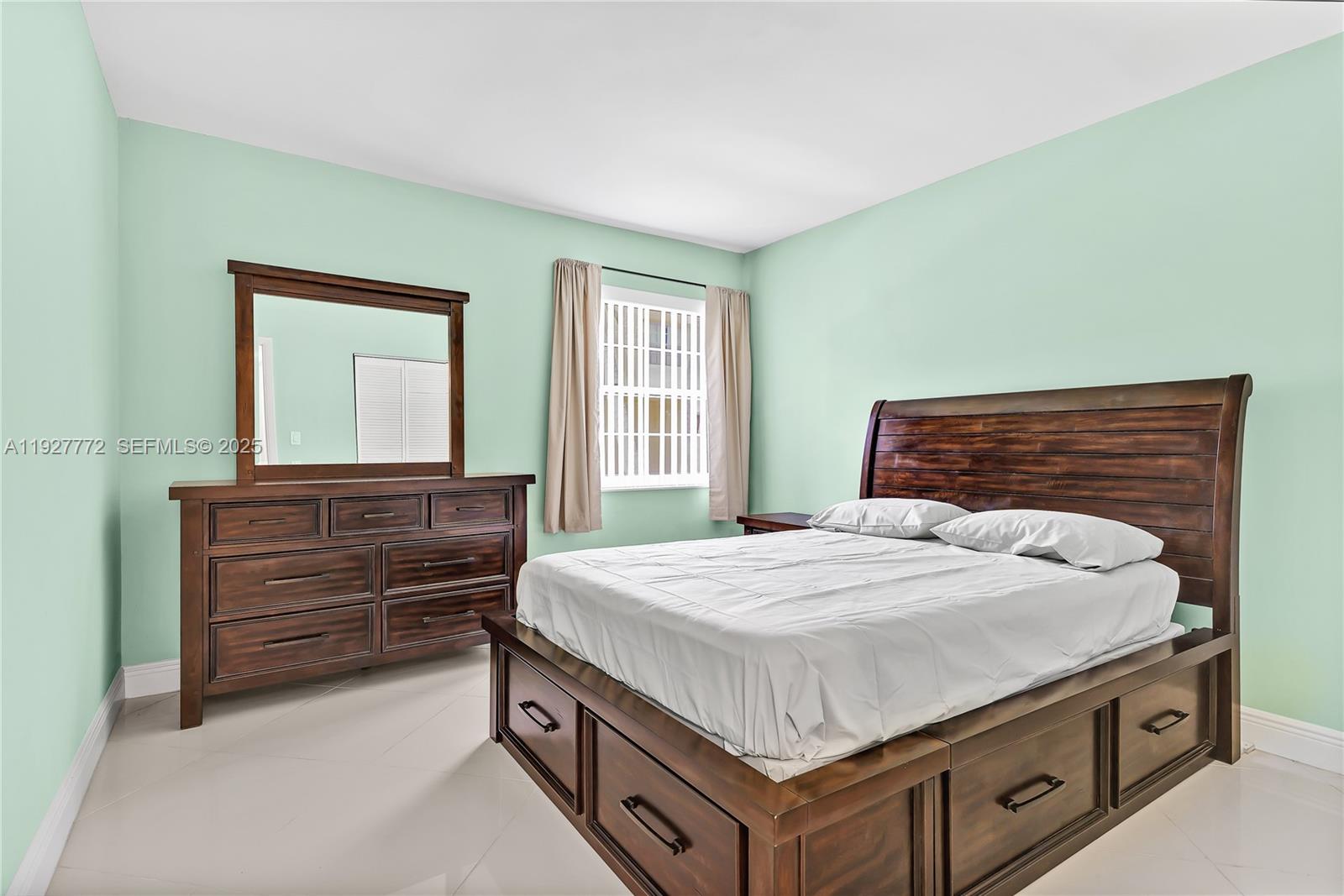 9311 Southwest 4th Street, Unit 105B Miami, FL 33174 - Photo 15 of 19 a bedroom with a bed and a dresser