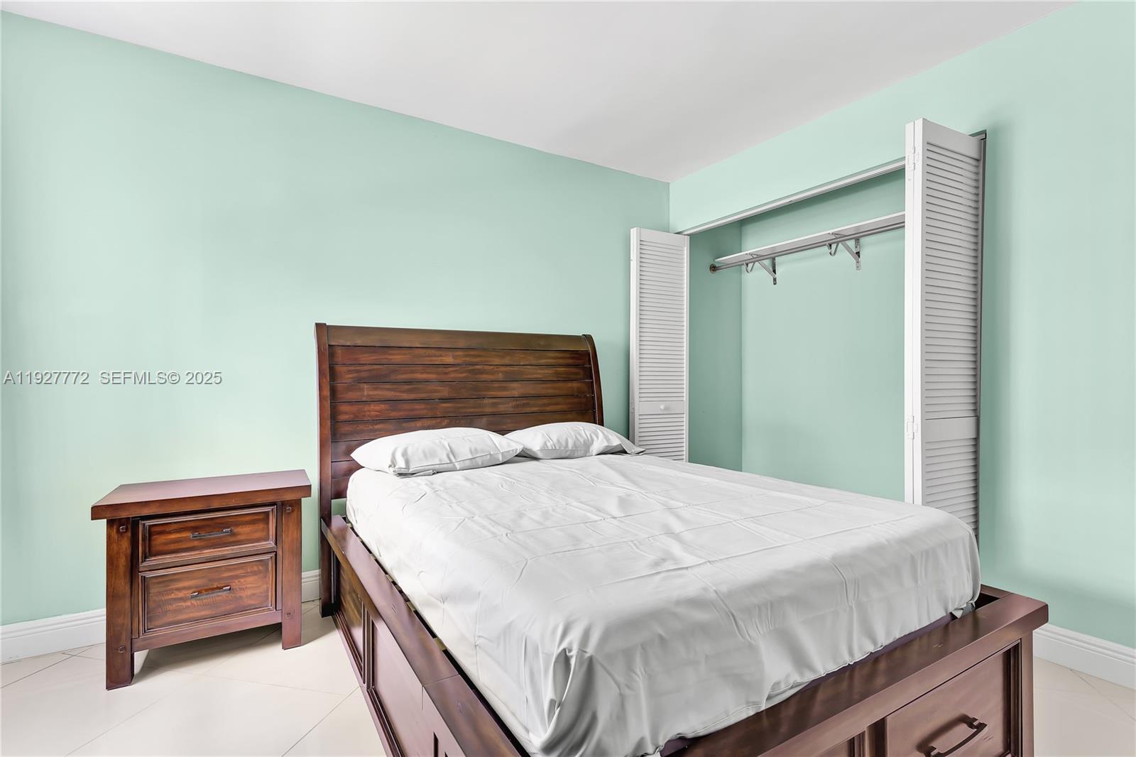 9311 Southwest 4th Street, Unit 105B Miami, FL 33174 - Photo 16 of 19 a bedroom with a bed and dresser