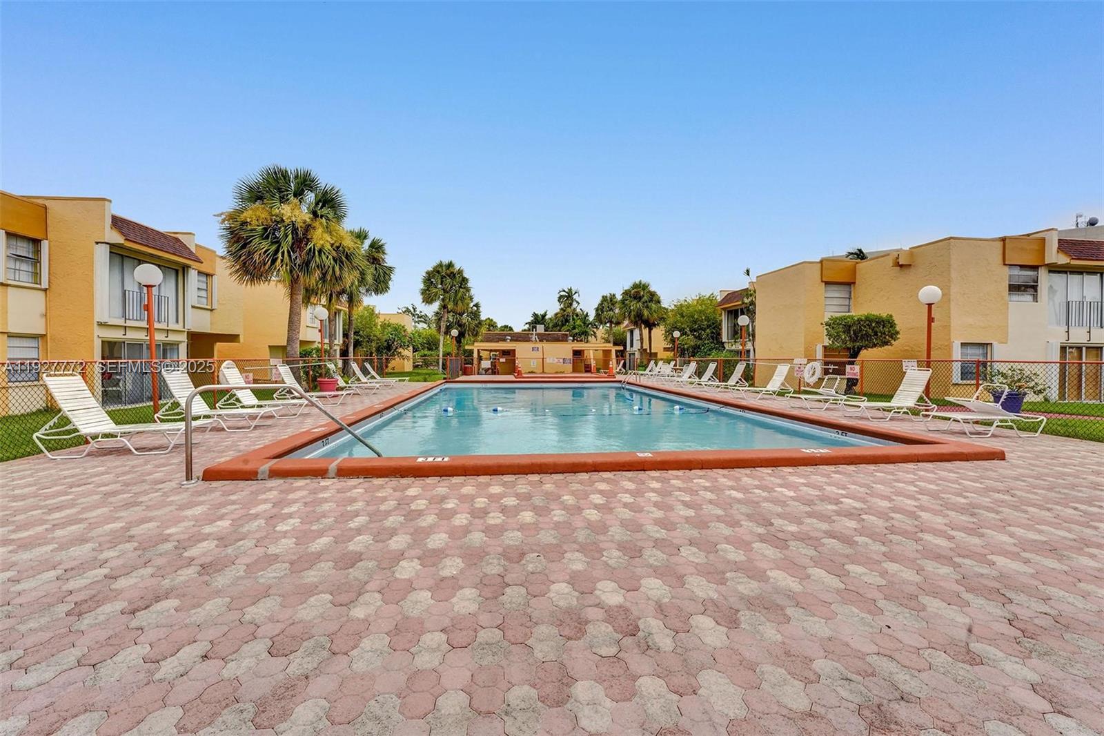 9311 Southwest 4th Street, Unit 105B Miami, FL 33174 - Photo 17 of 19 a view of swimming pool with outdoor seating