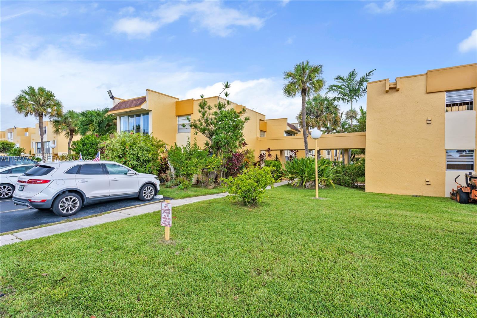 9311 Southwest 4th Street, Unit 105B Miami, FL 33174 - Photo 2 of 19 a car parked in front of a house with a big yard