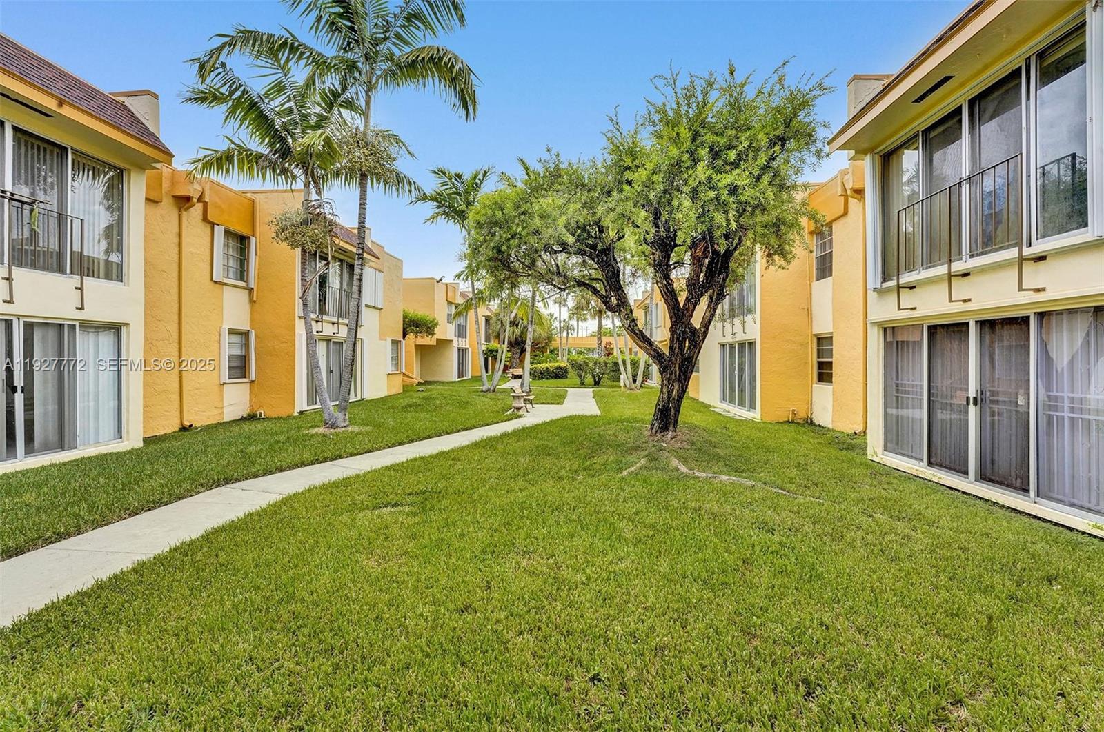 9311 Southwest 4th Street, Unit 105B Miami, FL 33174 - Photo 4 of 19 a view of a yard in front of a building