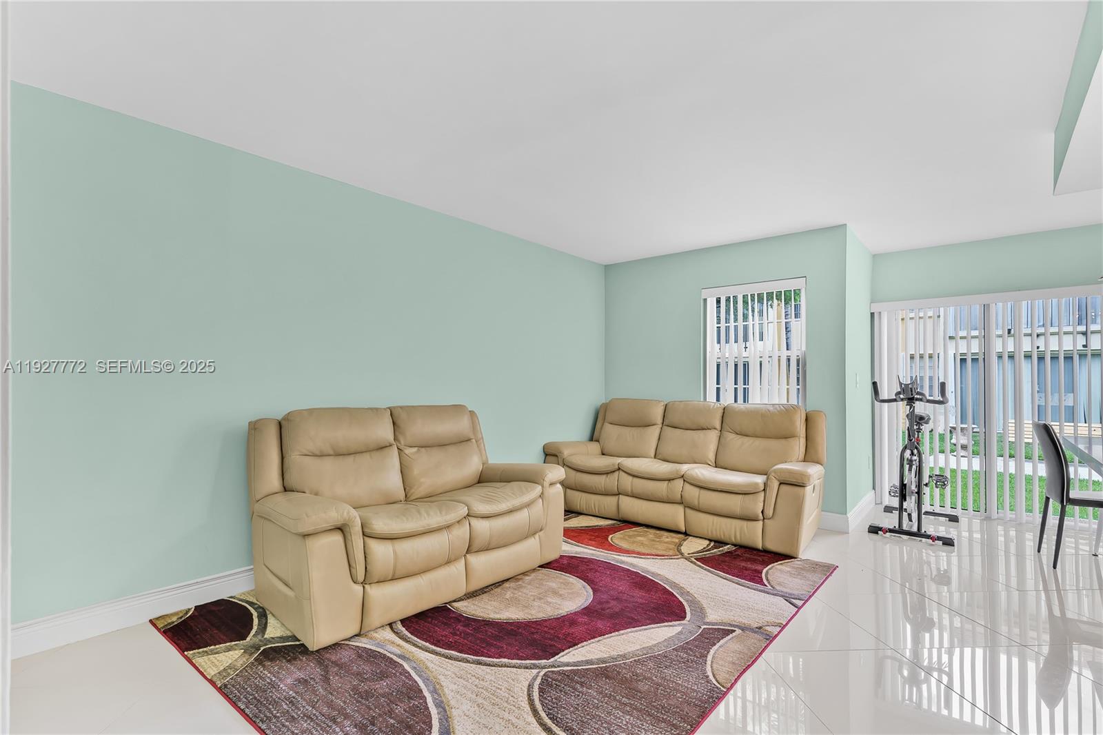9311 Southwest 4th Street, Unit 105B Miami, FL 33174 - Photo 6 of 19 a living room with furniture rug and wooden floor