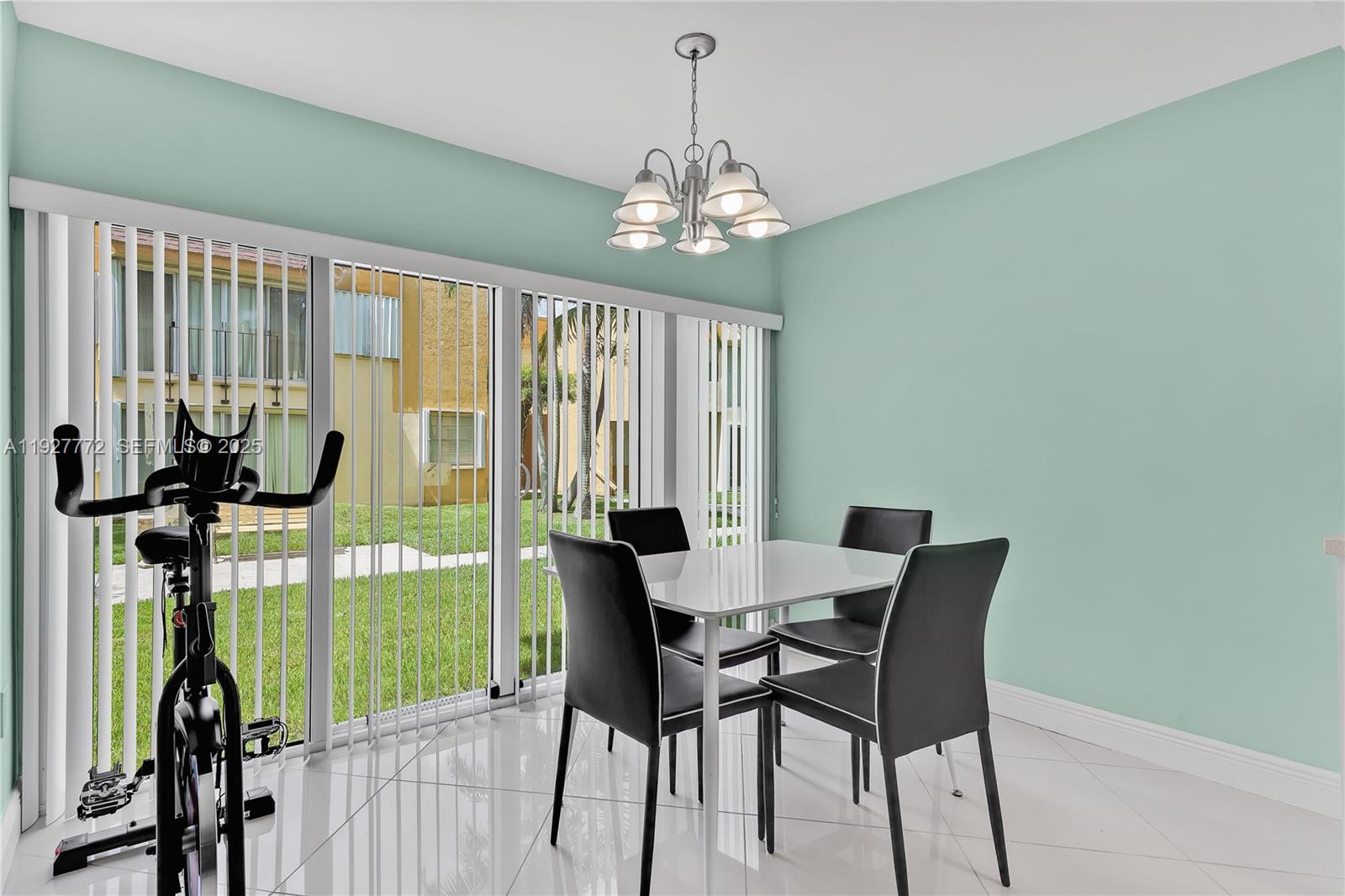 9311 Southwest 4th Street, Unit 105B Miami, FL 33174 - Photo 7 of 19 a view of a dining room with furniture window and outside view