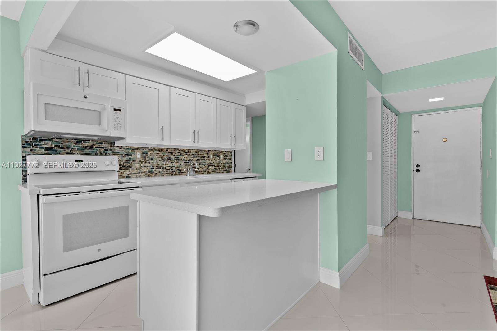 9311 Southwest 4th Street, Unit 105B Miami, FL 33174 - Photo 9 of 19 a kitchen with white cabinets and white appliances