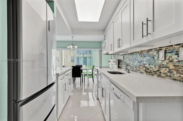 a kitchen with a sink a stove and chairs