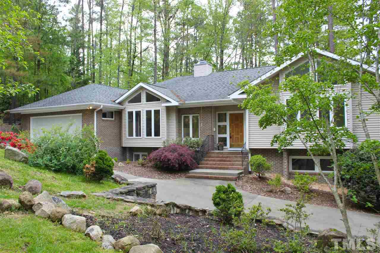 505 Booth Road Chapel Hill, NC 27516 - Photo 1 of 25 a front view of a house with a yard and potted plants