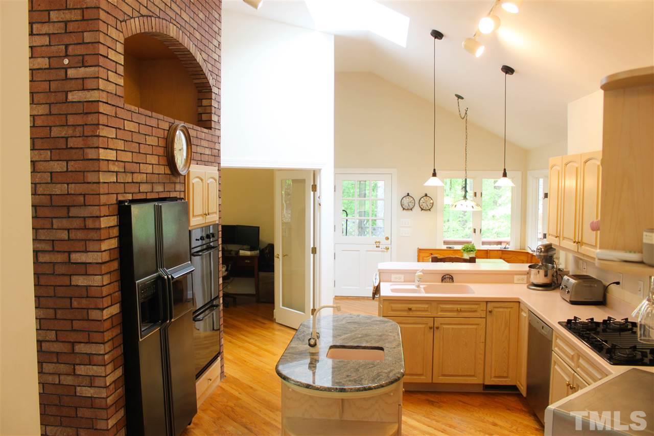 505 Booth Road Chapel Hill, NC 27516 - Photo 2 of 25 a kitchen with stainless steel appliances a stove a sink refrigerator and a wooden floor